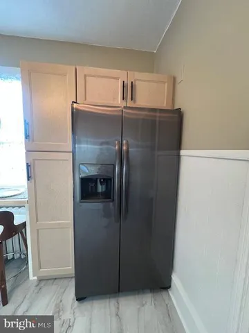 a kitchen with a stove a sink cabinets and dining table