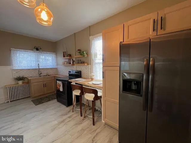 a kitchen with a sink cabinets and window