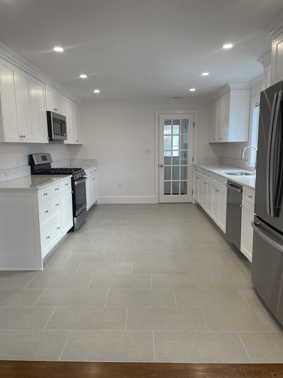 29 Crescent Road, Unit 29 Belmont, MA 02478 - Photo 7 of 21 a large kitchen with cabinets and stainless steel appliances