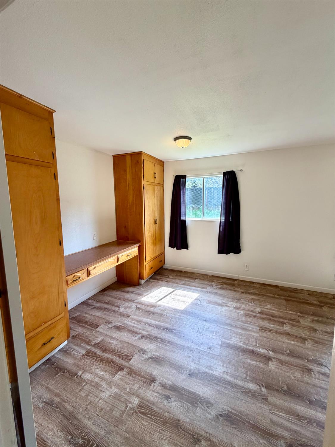 48963 River Park Road, Unit 13 Oakhurst, CA 93644 - Photo 12 of 33 Large built-in closet with desk in bedroom one.