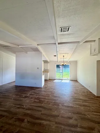 a view of a room with wooden floor