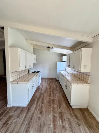 a kitchen with granite countertop a sink and a stove top oven