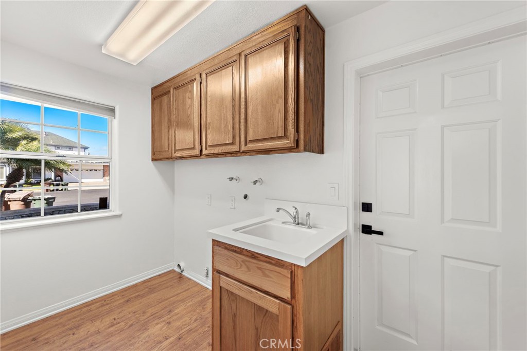 27552 Seascape Circle Dana Point, CA 92624 - Photo 17 of 39 a utility room with wooden floor washer and dryer