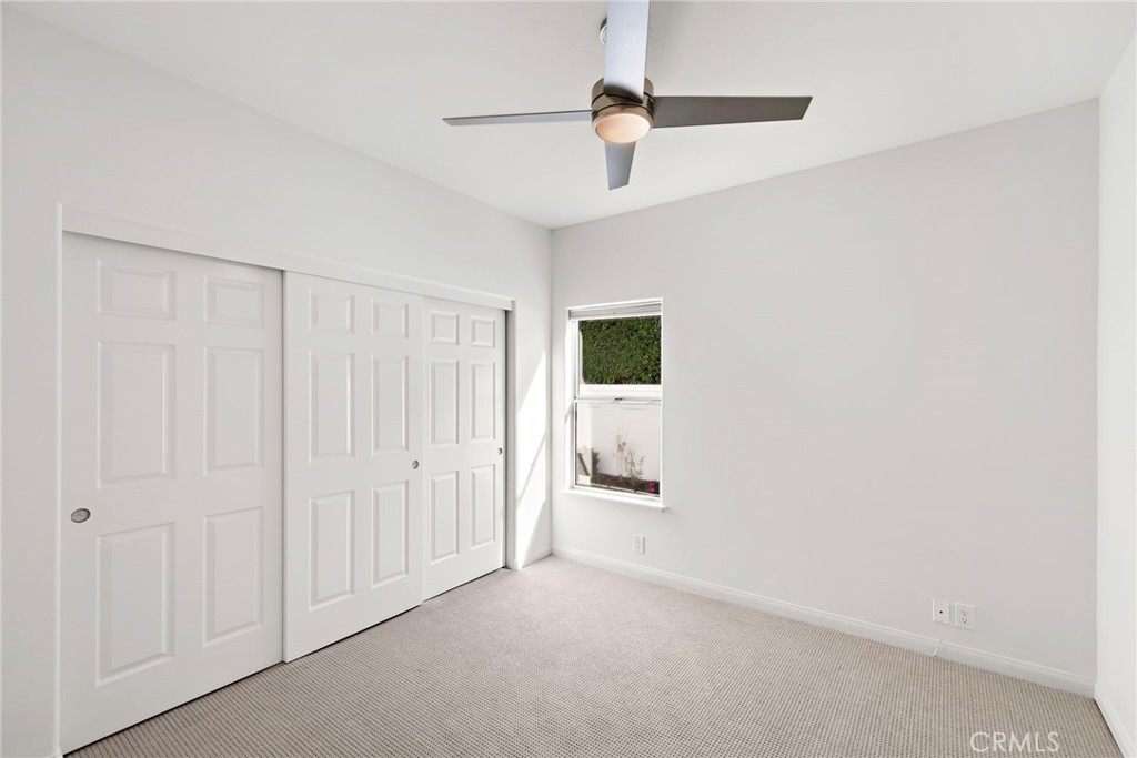 27552 Seascape Circle Dana Point, CA 92624 - Photo 34 of 39 a view of a livingroom with a white walls & a ceiling fan