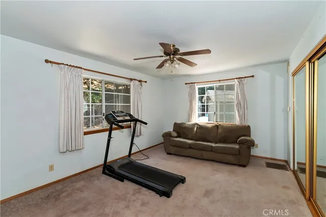 a living room with furniture gym equipment and a window