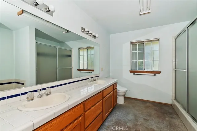 a spacious bathroom with a granite countertop sink and a mirror