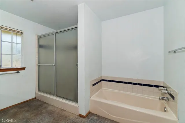 a bathroom with a tub and shower