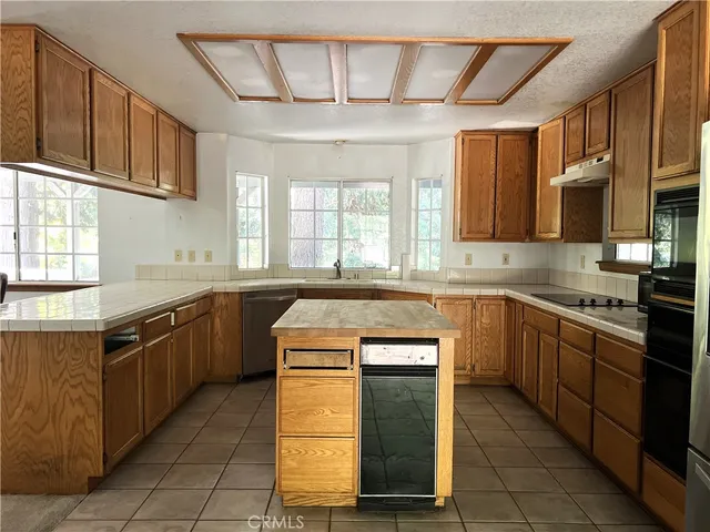a kitchen with stainless steel appliances granite countertop a sink and cabinets