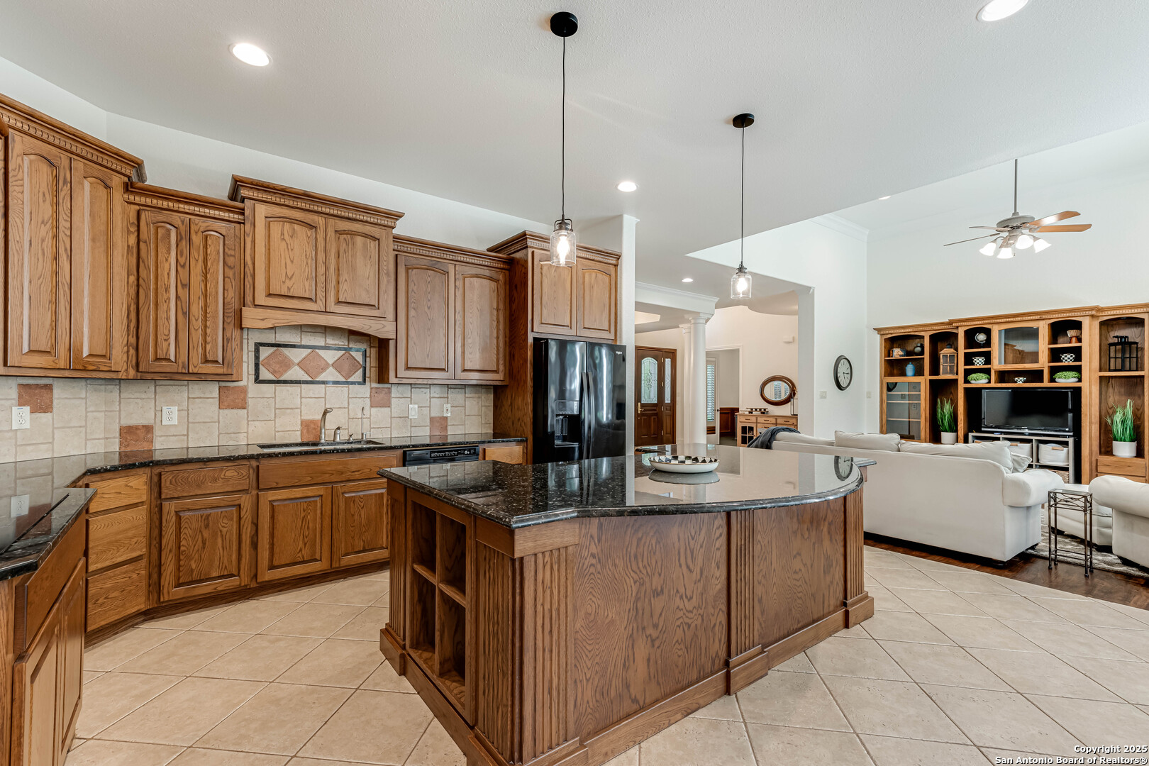 132 Long Bow Road Shavano Park, TX 78231 - Photo 15 of 50 a kitchen with stainless steel appliances granite countertop a sink counter space cabinets and a view of living room
