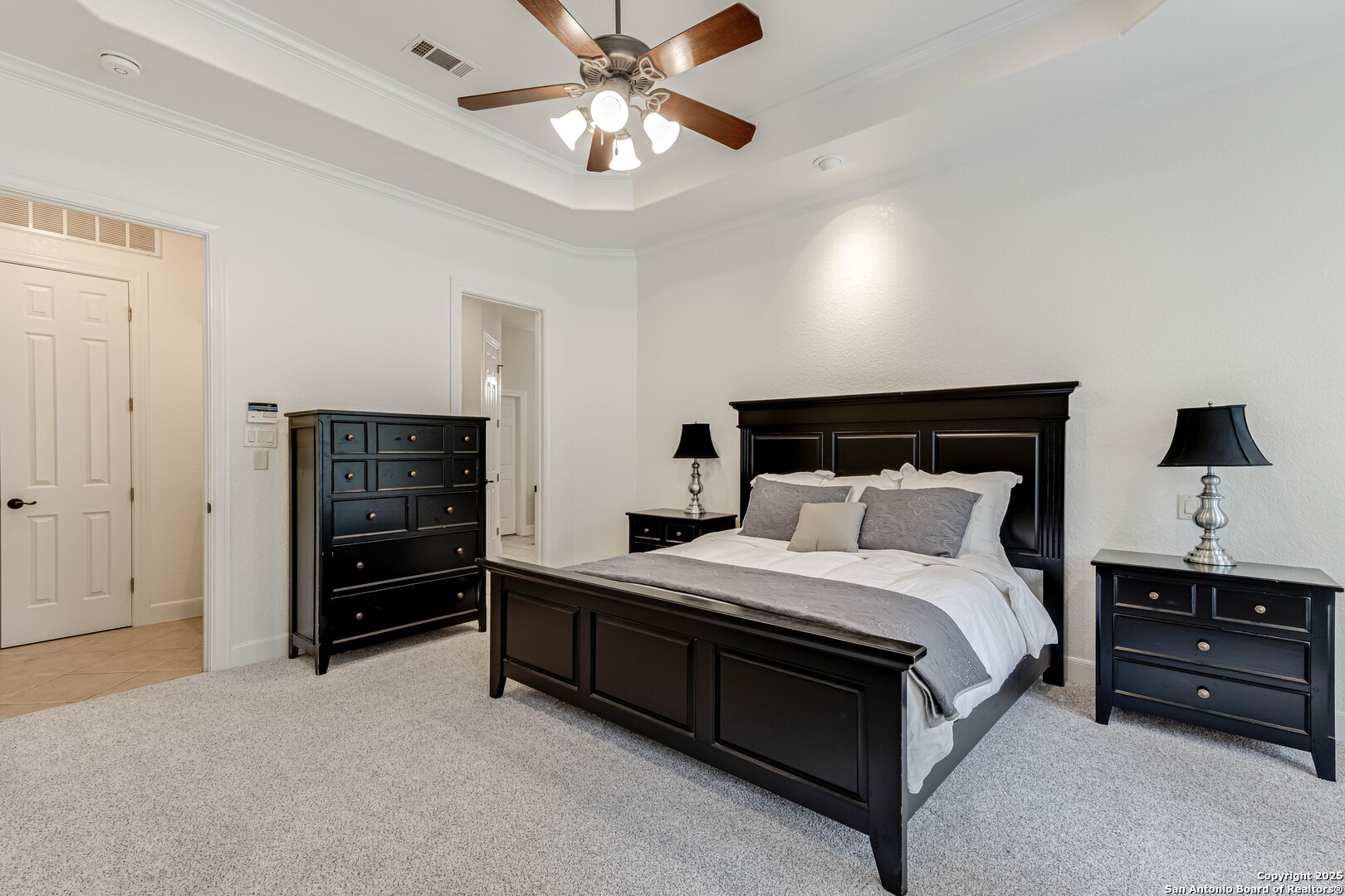 132 Long Bow Road Shavano Park, TX 78231 - Photo 24 of 50 a bedroom with a bed and a chandelier