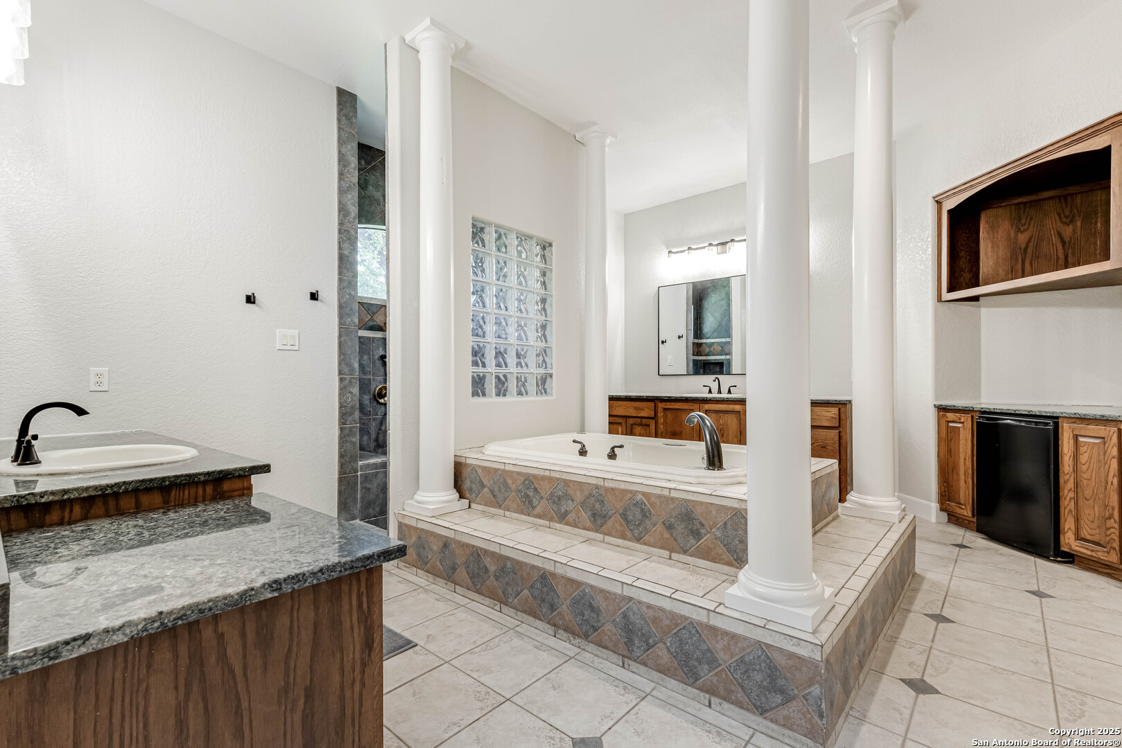 132 Long Bow Road Shavano Park, TX 78231 - Photo 28 of 50 a spacious bathroom with a granite countertop tub sink and mirror