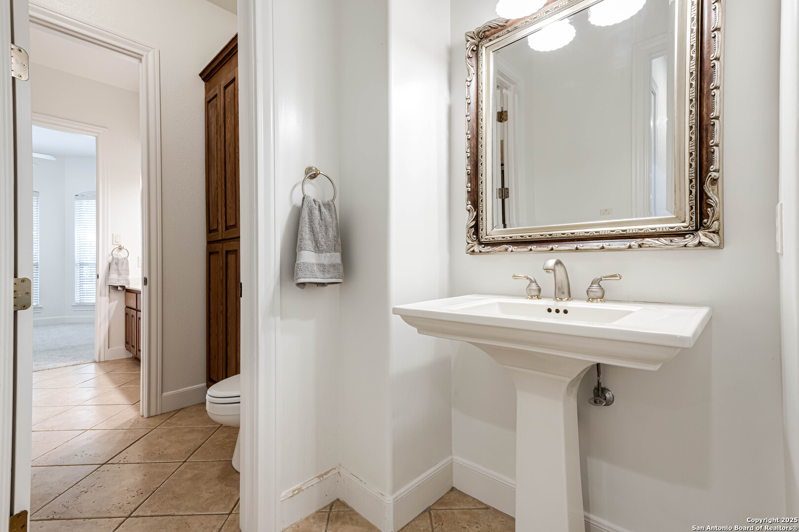 132 Long Bow Road Shavano Park, TX 78231 - Photo 36 of 50 a bathroom with a sink a mirror a vanity and a shower