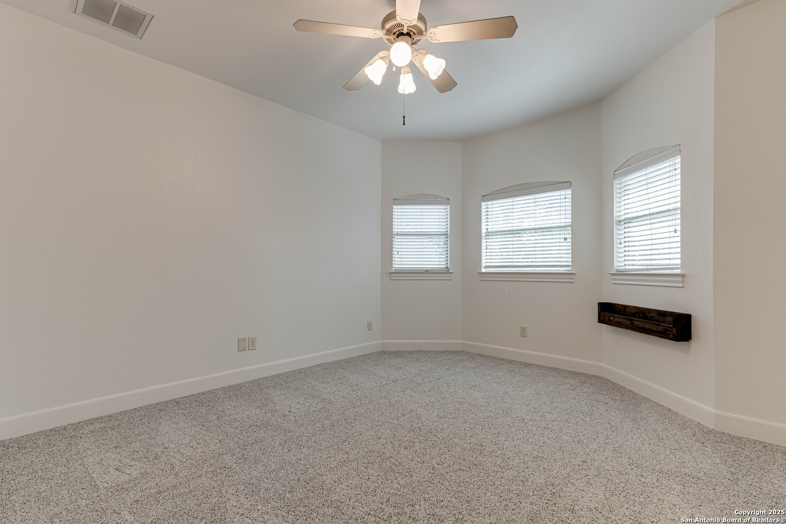 132 Long Bow Road Shavano Park, TX 78231 - Photo 38 of 50 an empty room with windows and chandelier fan