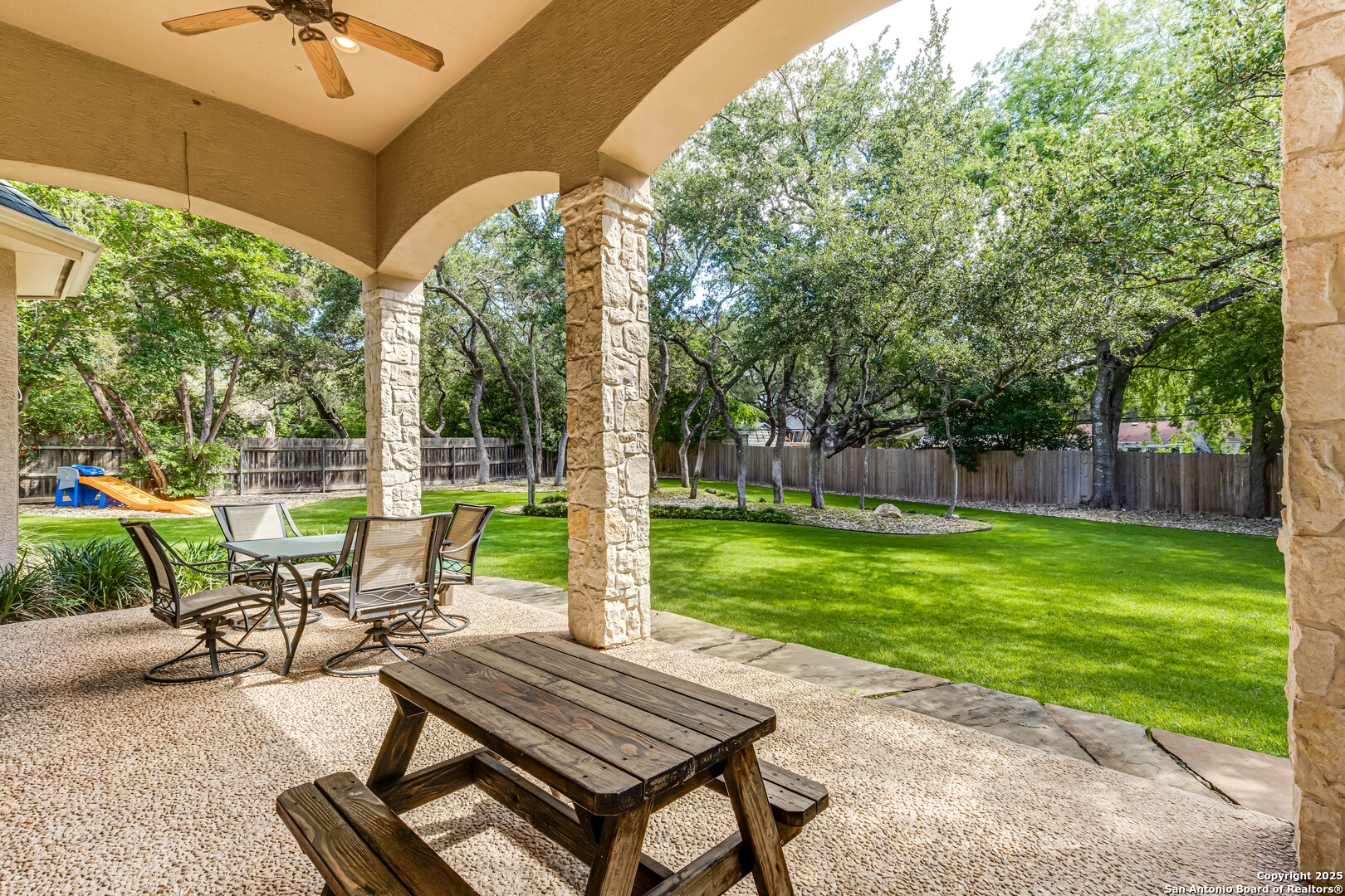 132 Long Bow Road Shavano Park, TX 78231 - Photo 45 of 50 a view of a patio with a table chairs and a backyard