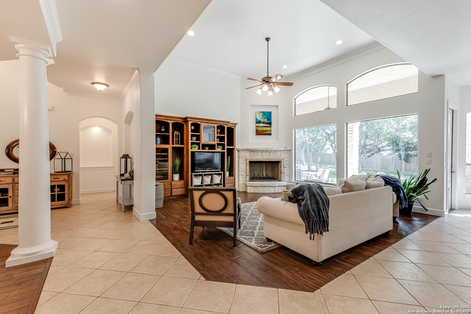 132 Long Bow Road Shavano Park, TX 78231 - Photo 8 of 50 a living room with furniture a fireplace and a chandelier