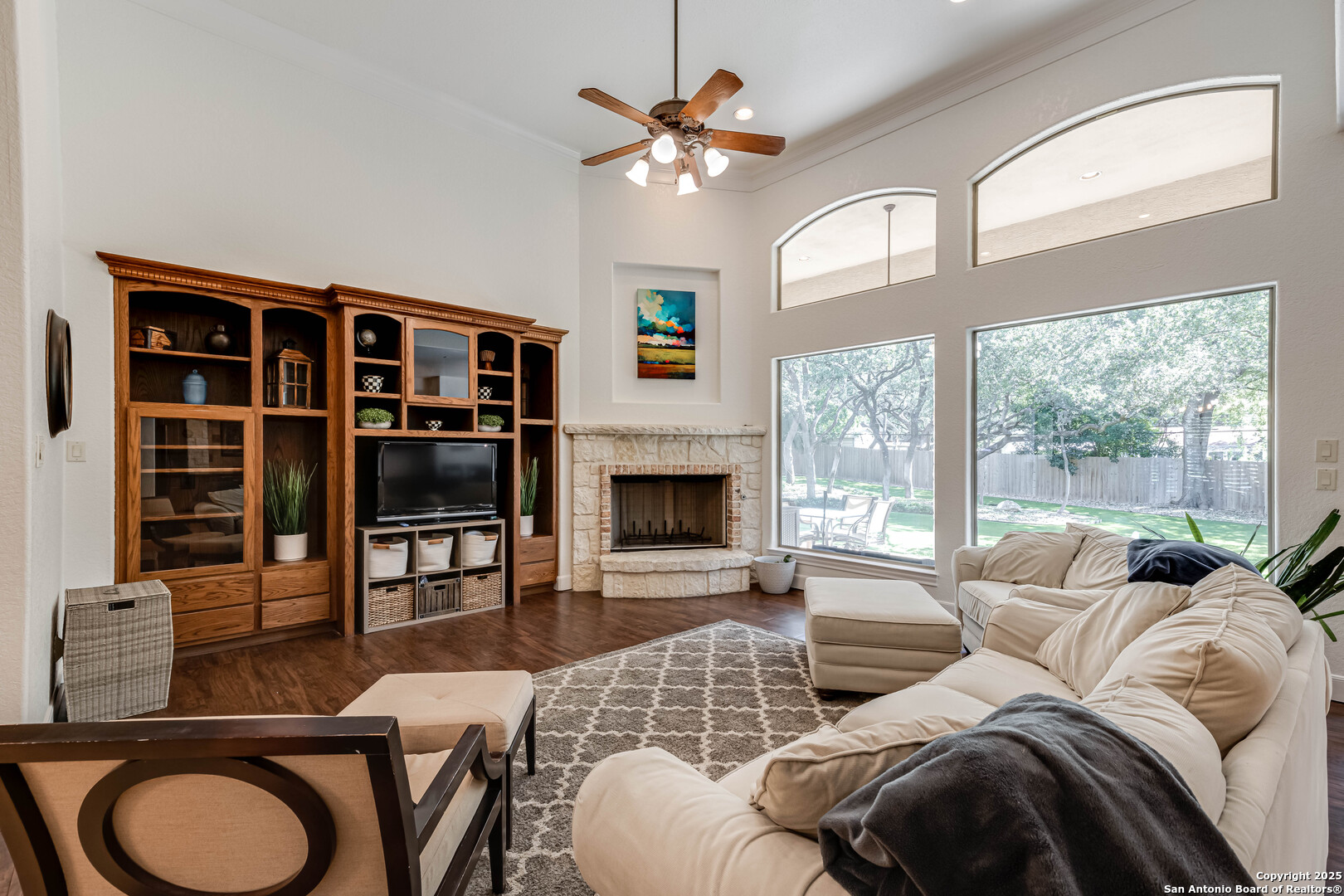 132 Long Bow Road Shavano Park, TX 78231 - Photo 9 of 50 a living room with furniture a fireplace and a flat screen tv