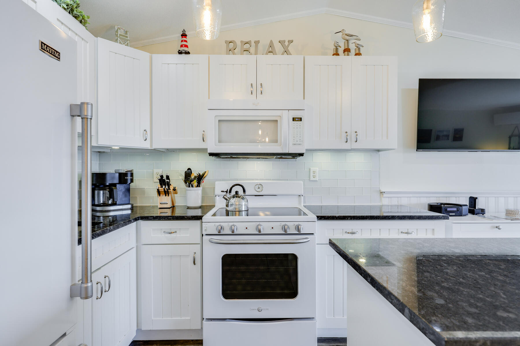 132 Shore Road, Unit 48 Truro, MA 02666 - Photo 11 of 35 a kitchen with granite countertop white cabinets and white appliances