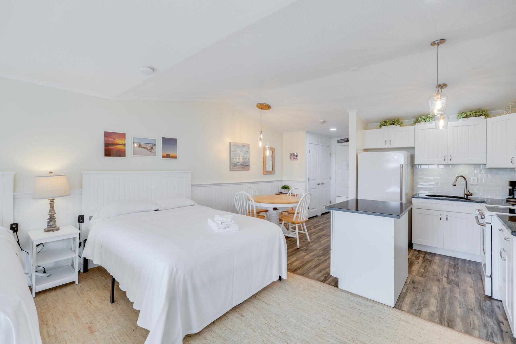 132 Shore Road, Unit 48 Truro, MA 02666 - Photo 18 of 35 a large room with a bed and a view of kitchen