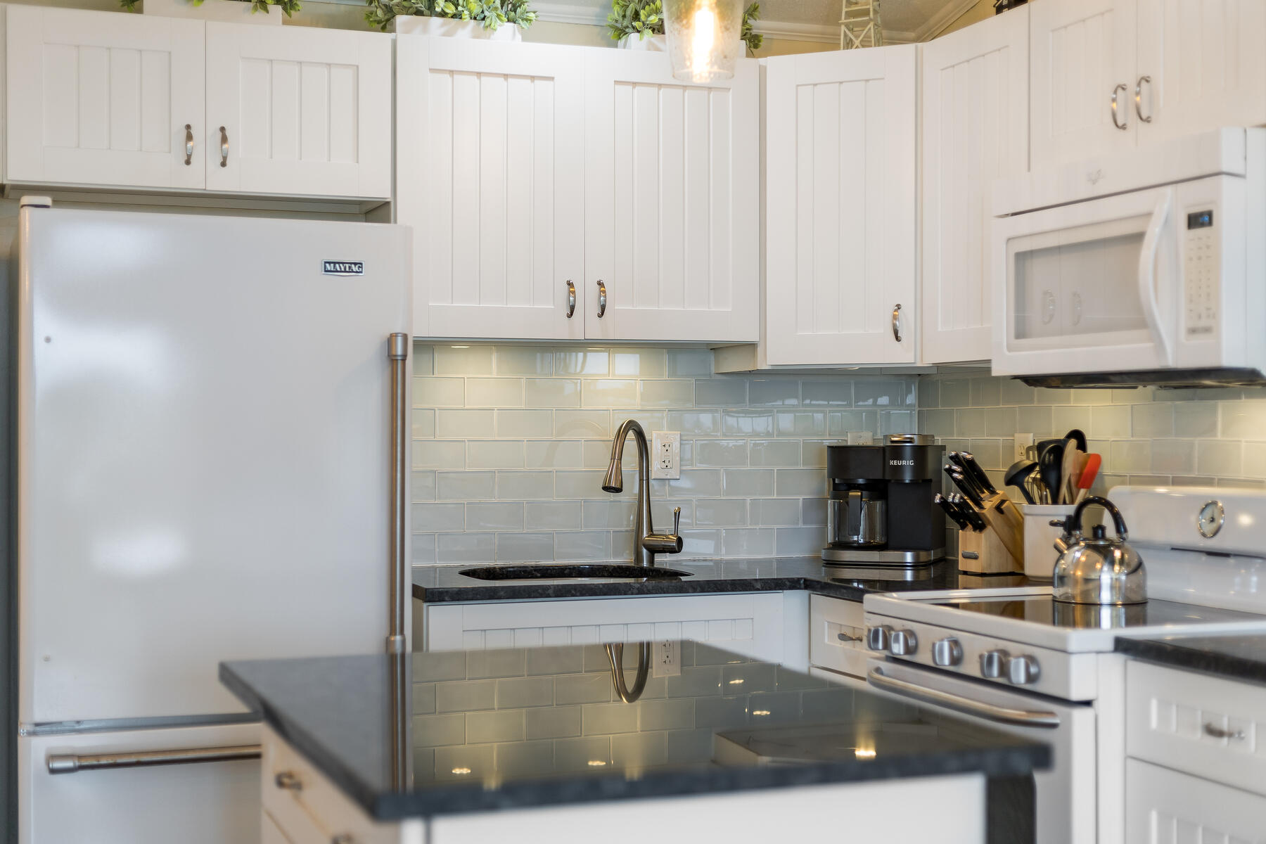 132 Shore Road, Unit 48 Truro, MA 02666 - Photo 23 of 35 a kitchen with a sink and cabinets