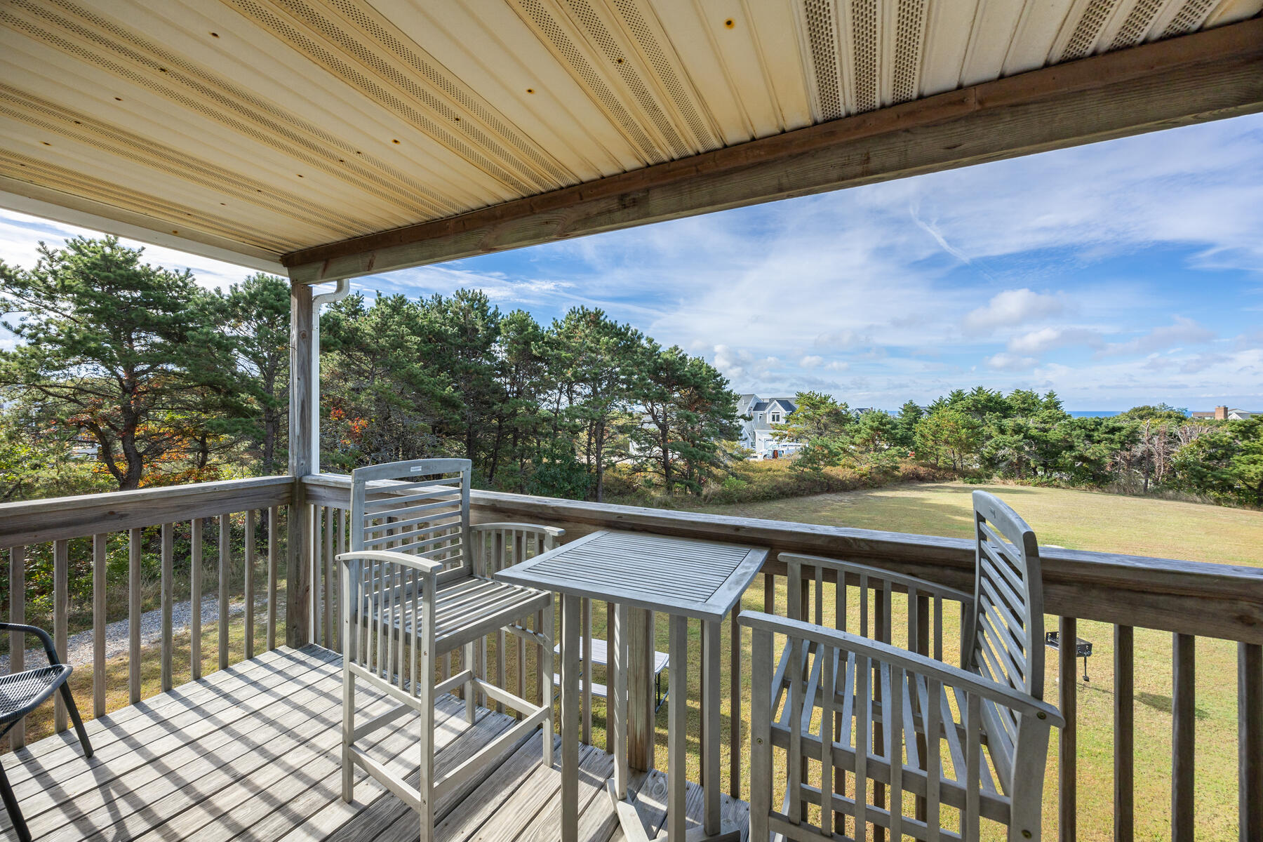 132 Shore Road, Unit 48 Truro, MA 02666 - Photo 3 of 35 a view of a balcony with wooden floor and outdoor seating