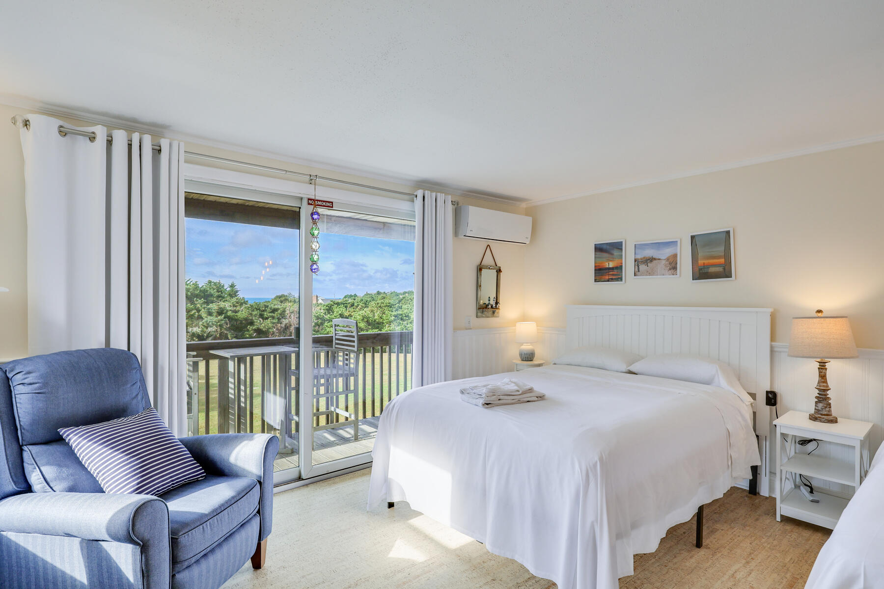 132 Shore Road, Unit 48 Truro, MA 02666 - Photo 8 of 35 a spacious bedroom with a bed and a couch