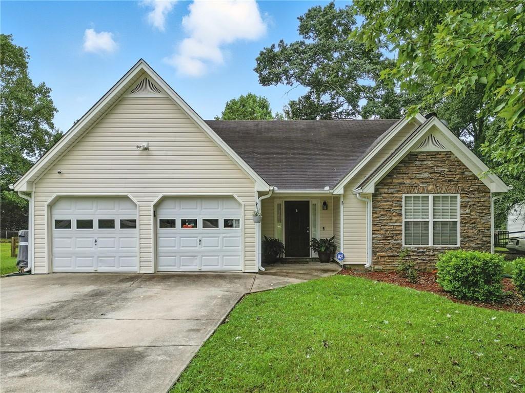 a front view of a house with a garden