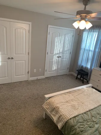 a bedroom with a bed and a chandelier