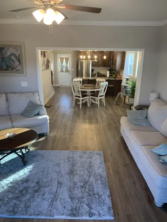 a living room with furniture and a chandelier