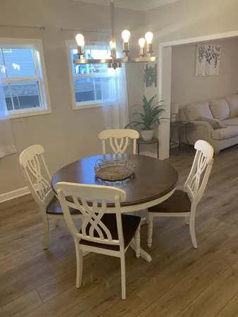 a dining room with furniture and wooden floor