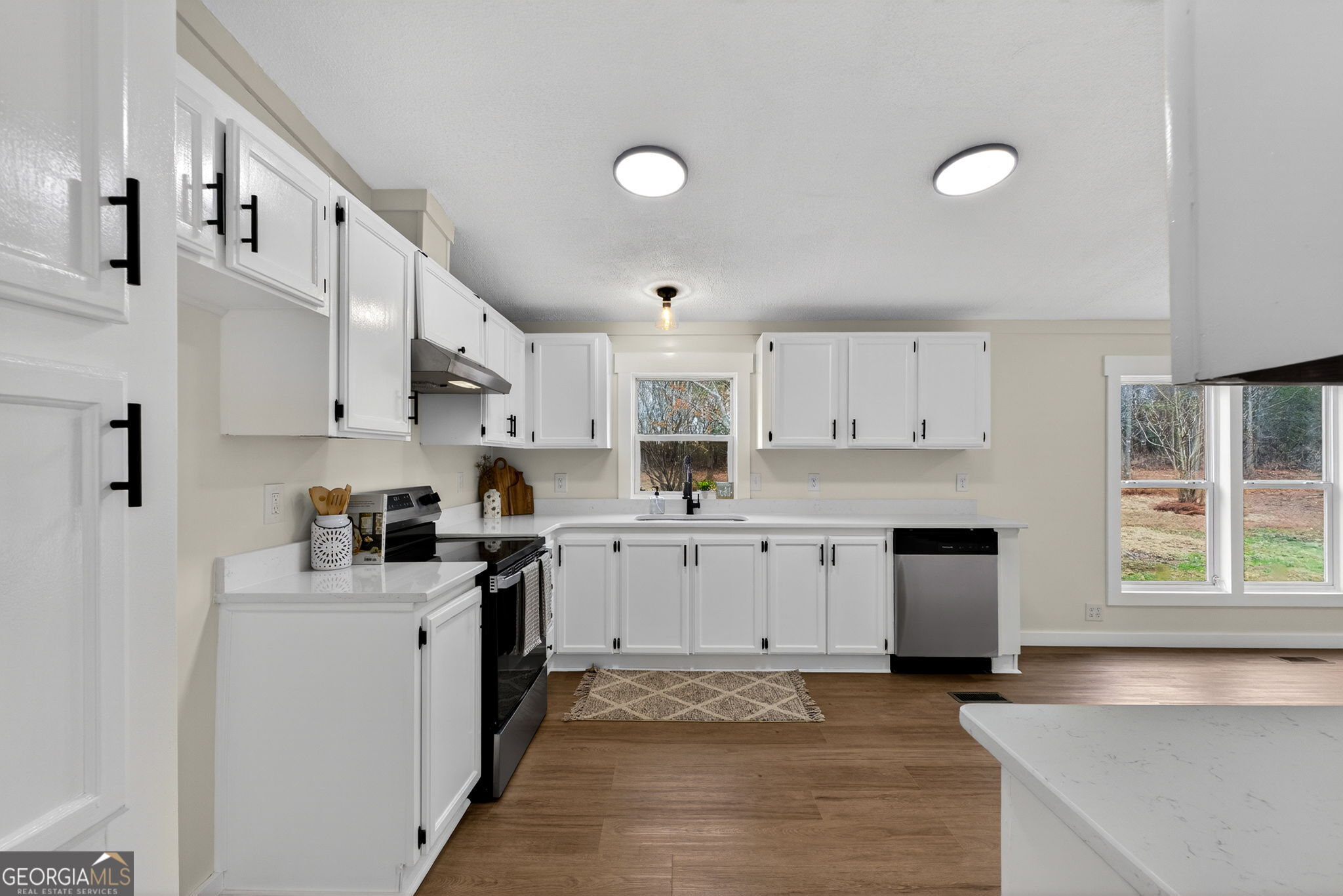 329 Brook Road Barnesville, GA 30204 - Photo 11 of 37 a kitchen with stainless steel appliances granite countertop a sink and cabinets
