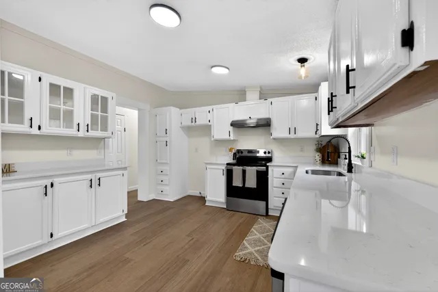 a kitchen with stainless steel appliances a refrigerator sink and cabinets