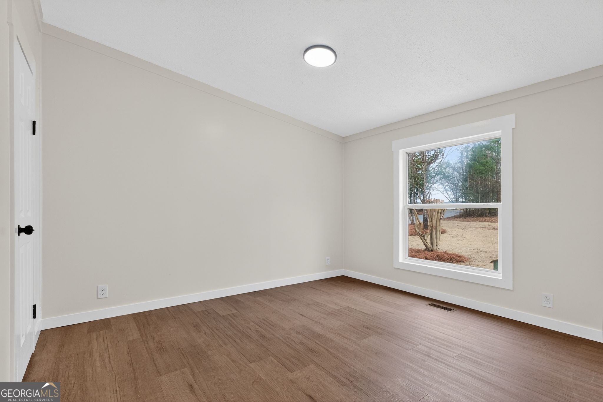 329 Brook Road Barnesville, GA 30204 - Photo 16 of 37 an empty room with wooden floor and windows