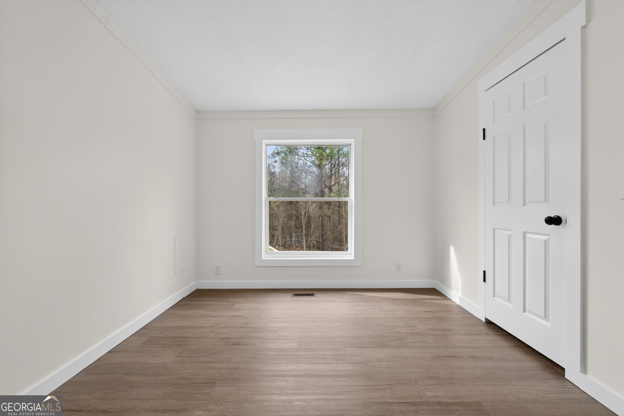 329 Brook Road Barnesville, GA 30204 - Photo 19 of 37 a view of an empty room with wooden floor and a window
