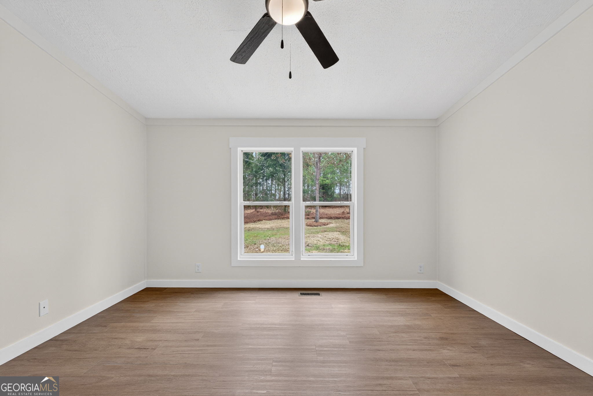 329 Brook Road Barnesville, GA 30204 - Photo 22 of 37 an empty room with a window and a ceiling fan