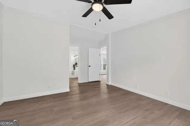a view of an empty room with wooden floor