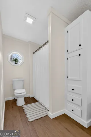 a bathroom with a toilet and a shower