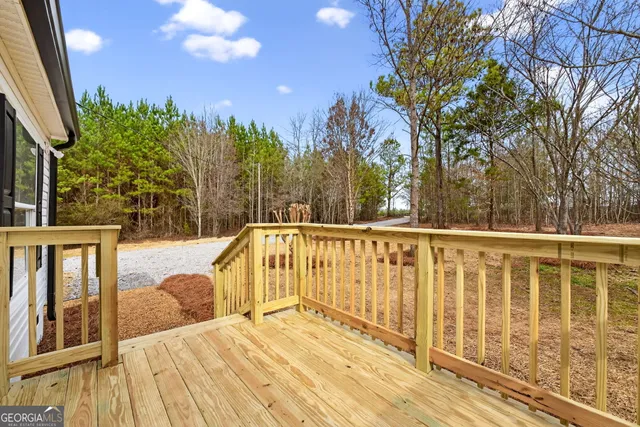 a view of balcony with wooden floor and fence