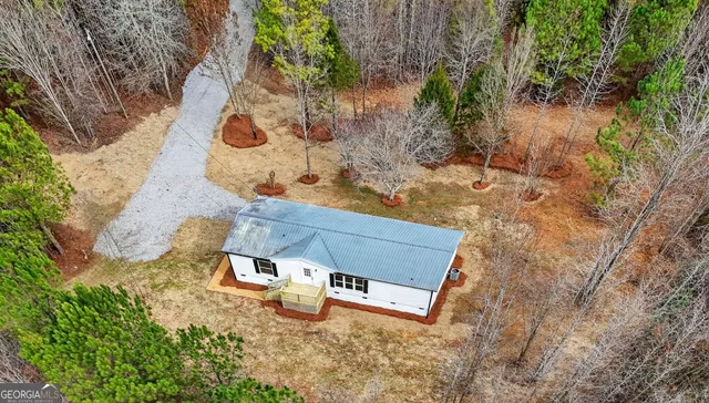 an aerial view of a backyard with chairs