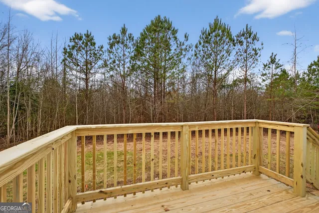 a view of a wooden deck with a backyard