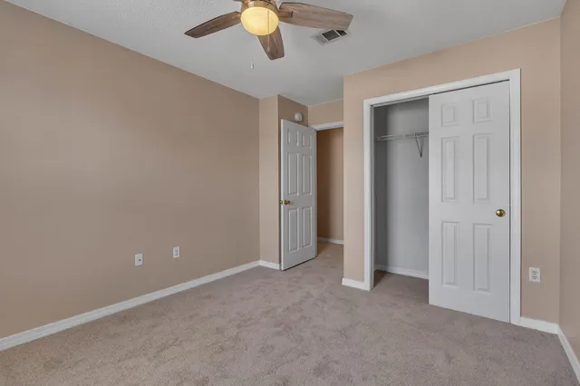 an empty room with closet area