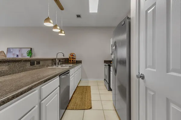 a kitchen with a sink and refrigerator