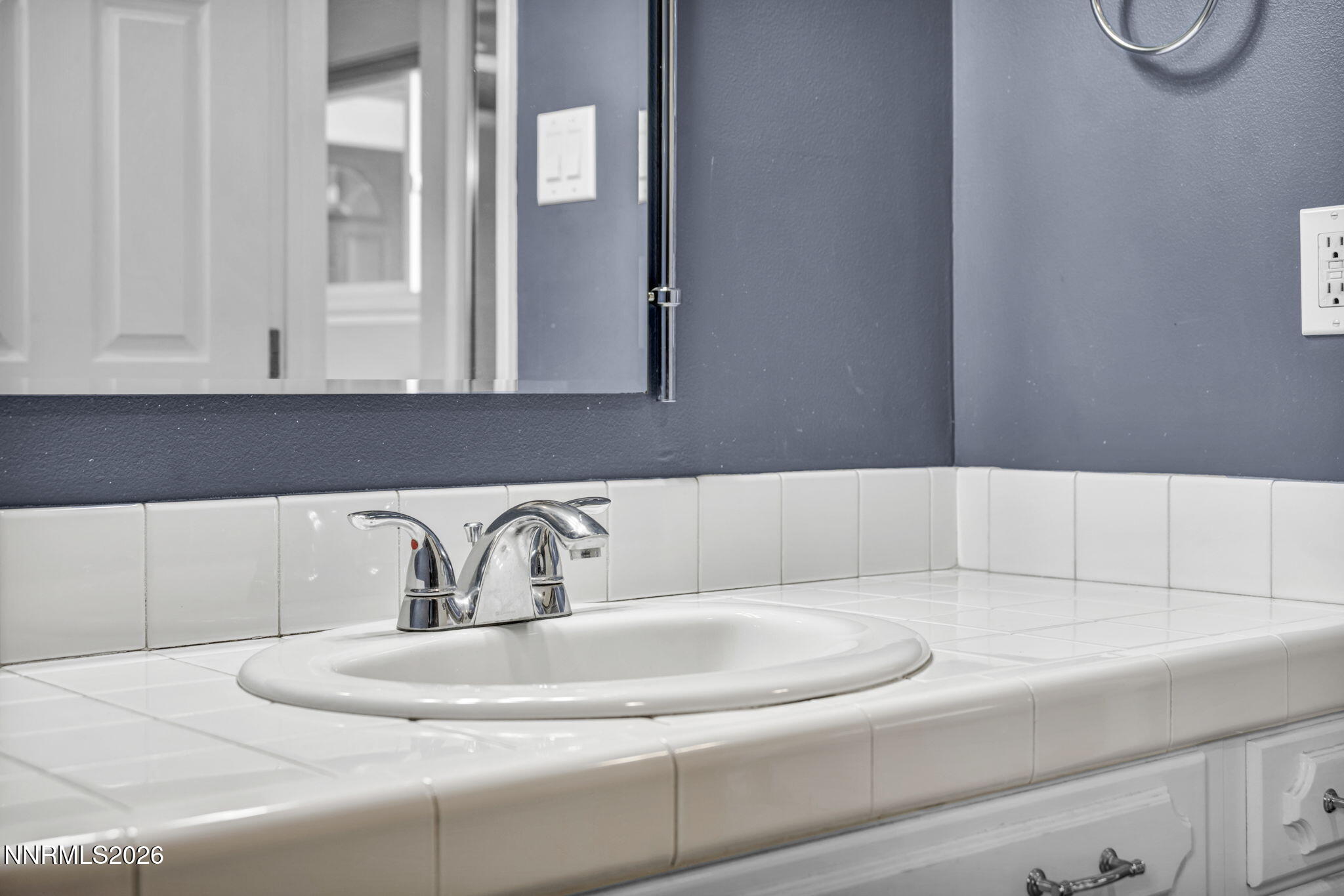 14190 Rim Rock Drive Reno, NV 89521 - Photo 35 of 68 a bathroom with a sink and a mirror