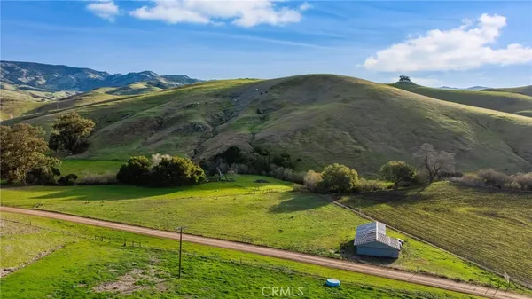 a view of a field with an ocean