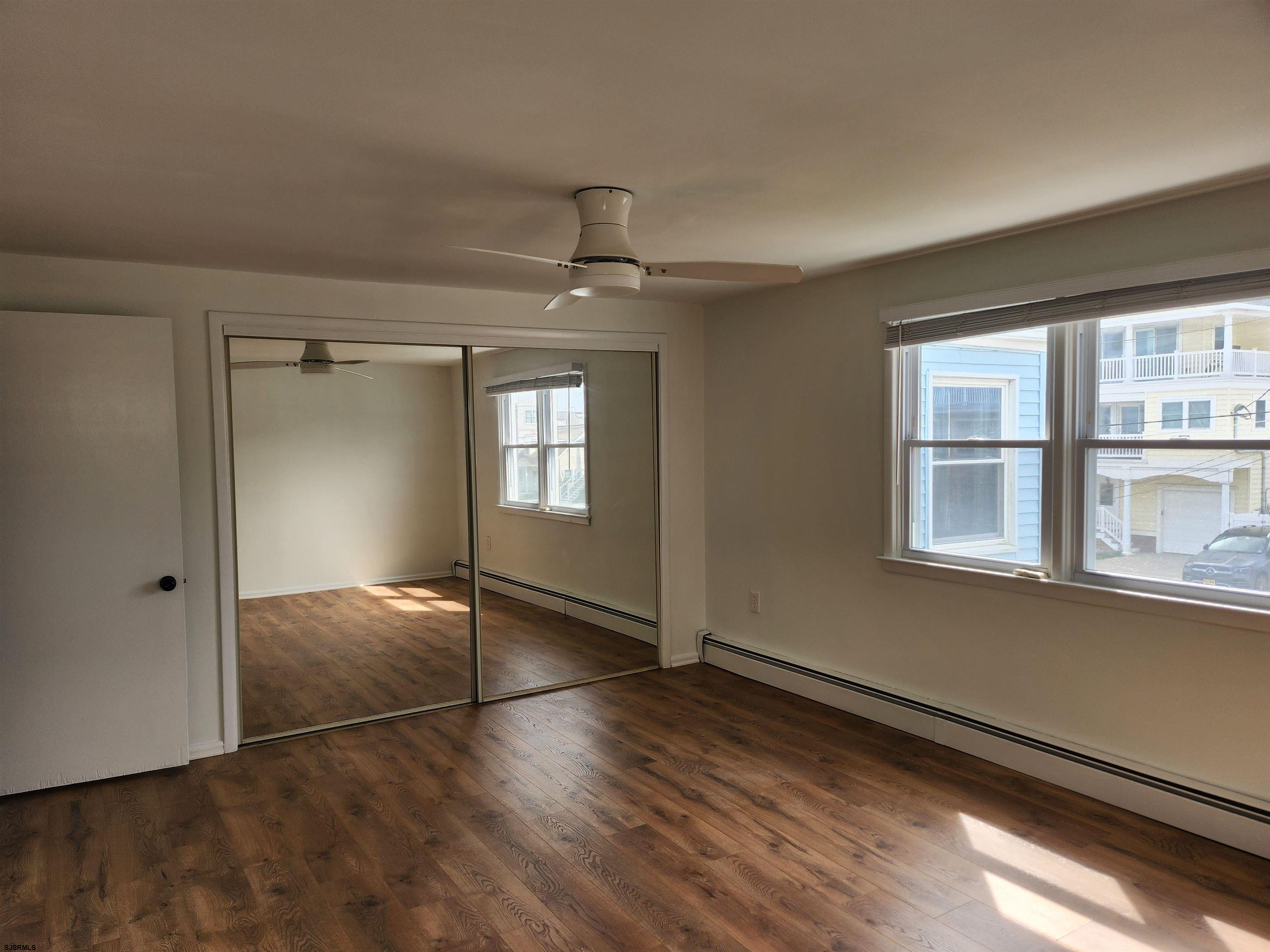 353 11th Street South, Unit 2 Brigantine, NJ 08203 - Photo 12 of 17 an empty room with wooden floor and windows