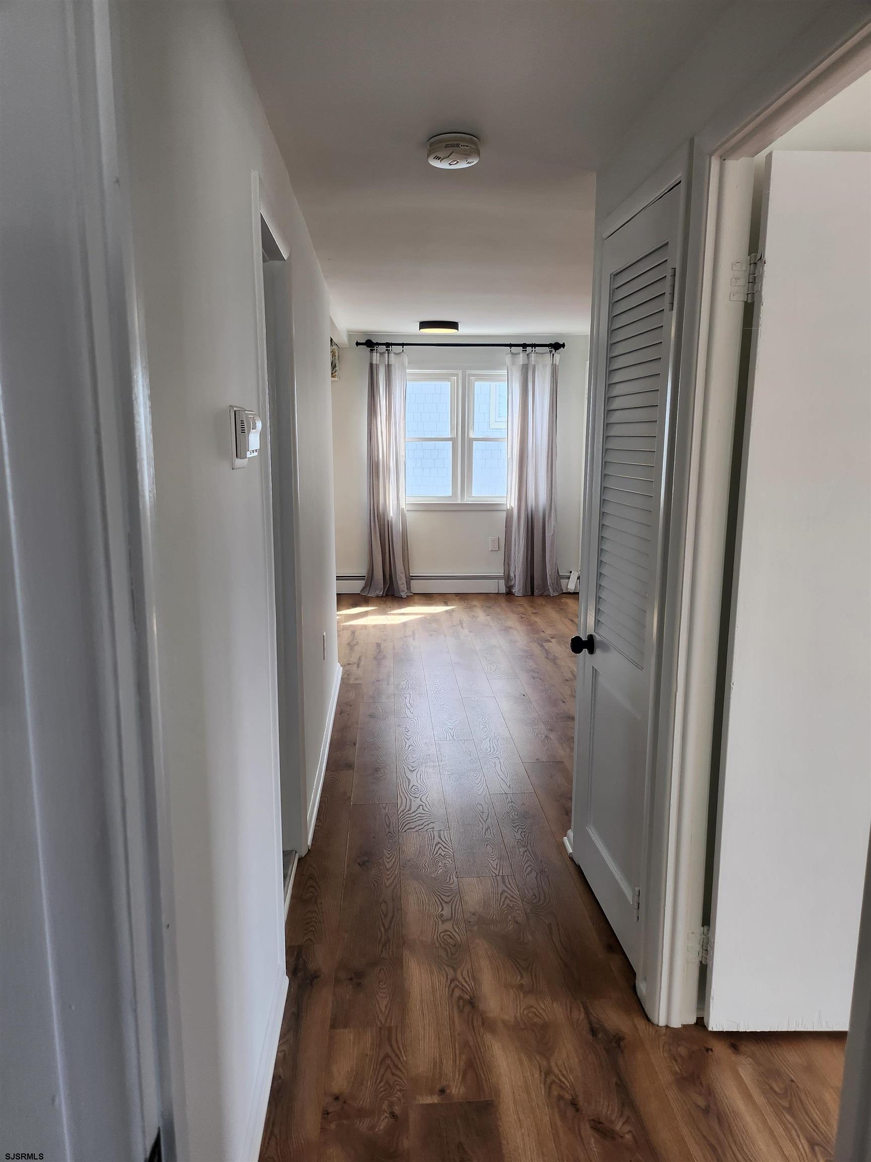 353 11th Street South, Unit 2 Brigantine, NJ 08203 - Photo 15 of 17 a view of a hallway with wooden floor