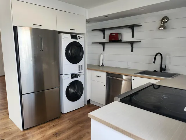 a utility room with sink dryer and washer