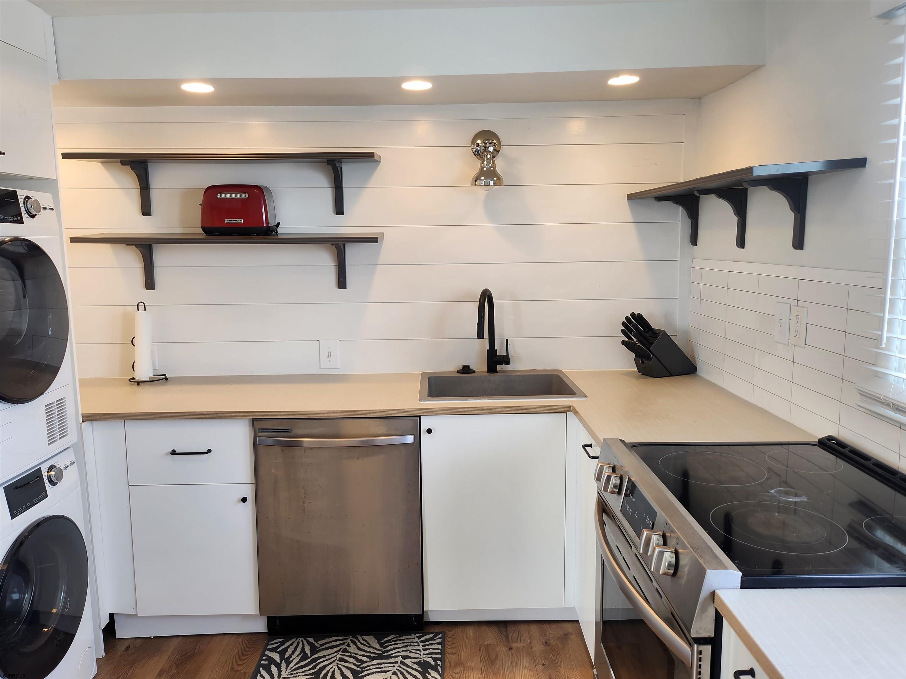 353 11th Street South, Unit 2 Brigantine, NJ 08203 - Photo 5 of 17 a view of a kitchen with stainless steel appliances granite countertop a sink and a stove