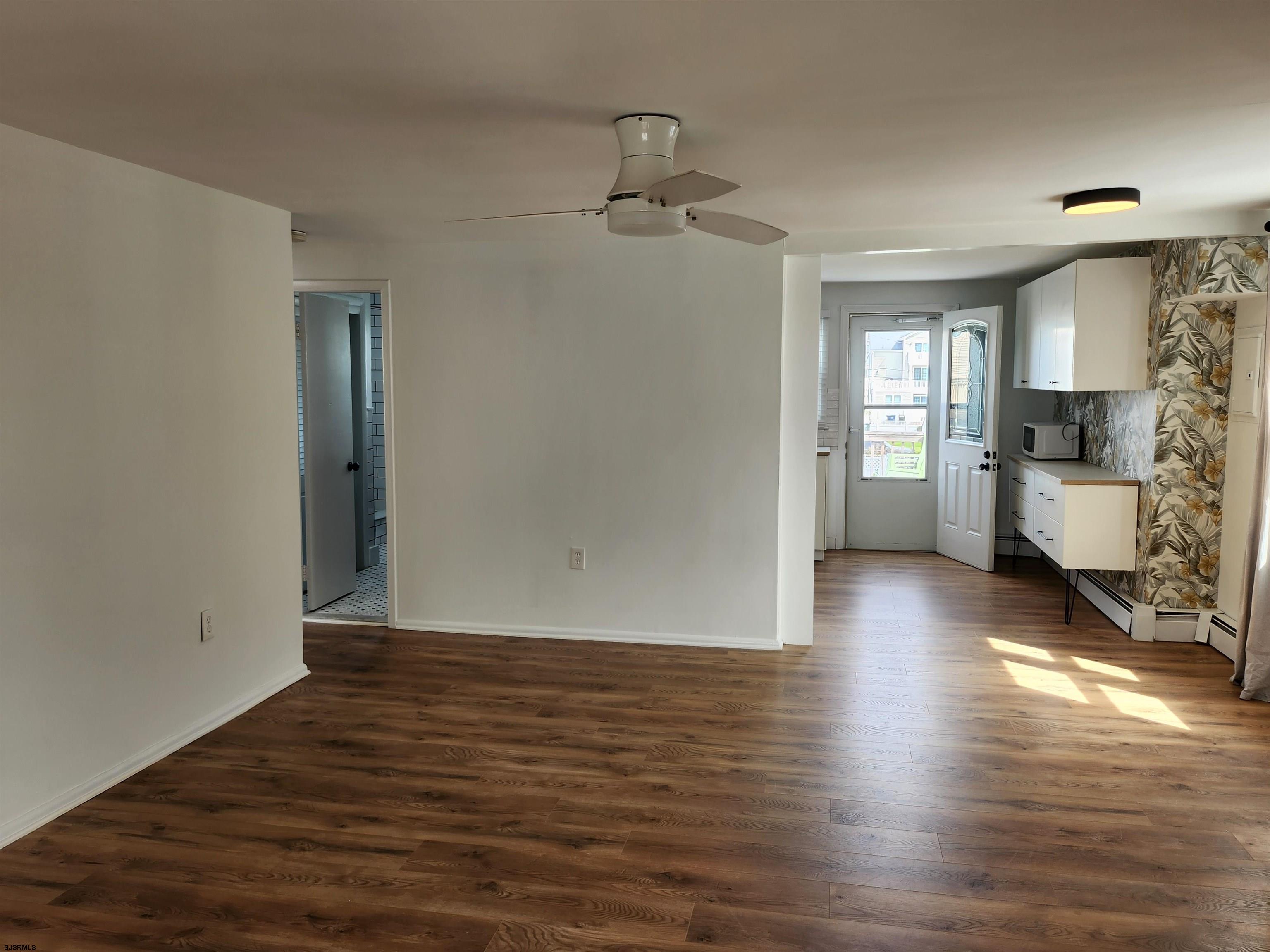 353 11th Street South, Unit 2 Brigantine, NJ 08203 - Photo 8 of 17 wooden floor in an empty room with a window