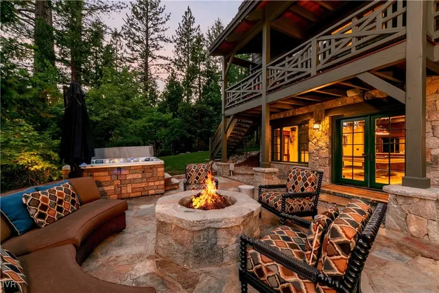 a outdoor space with patio fireplace and couches