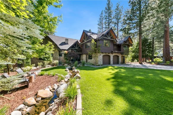 a view of a house with a yard and garden
